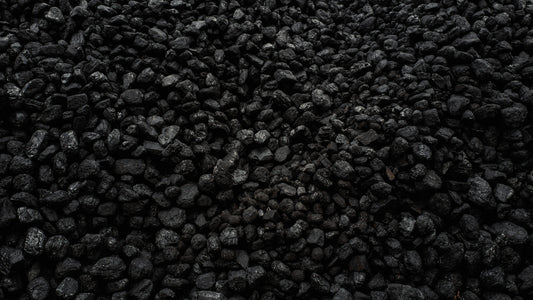 Pile of black charcoal pieces filling the frame
